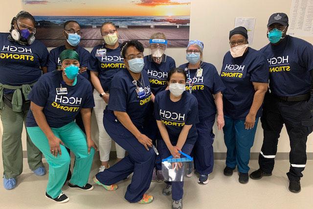 Group of doctors and nursing wearing masks and HCGH Strong t-shirts